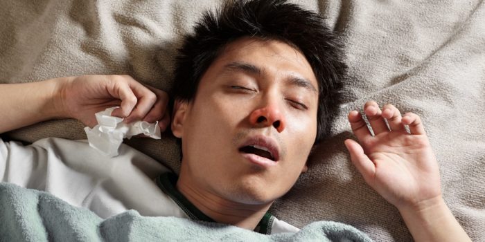 A male Chinese man is sleeping while catching cold and breathing